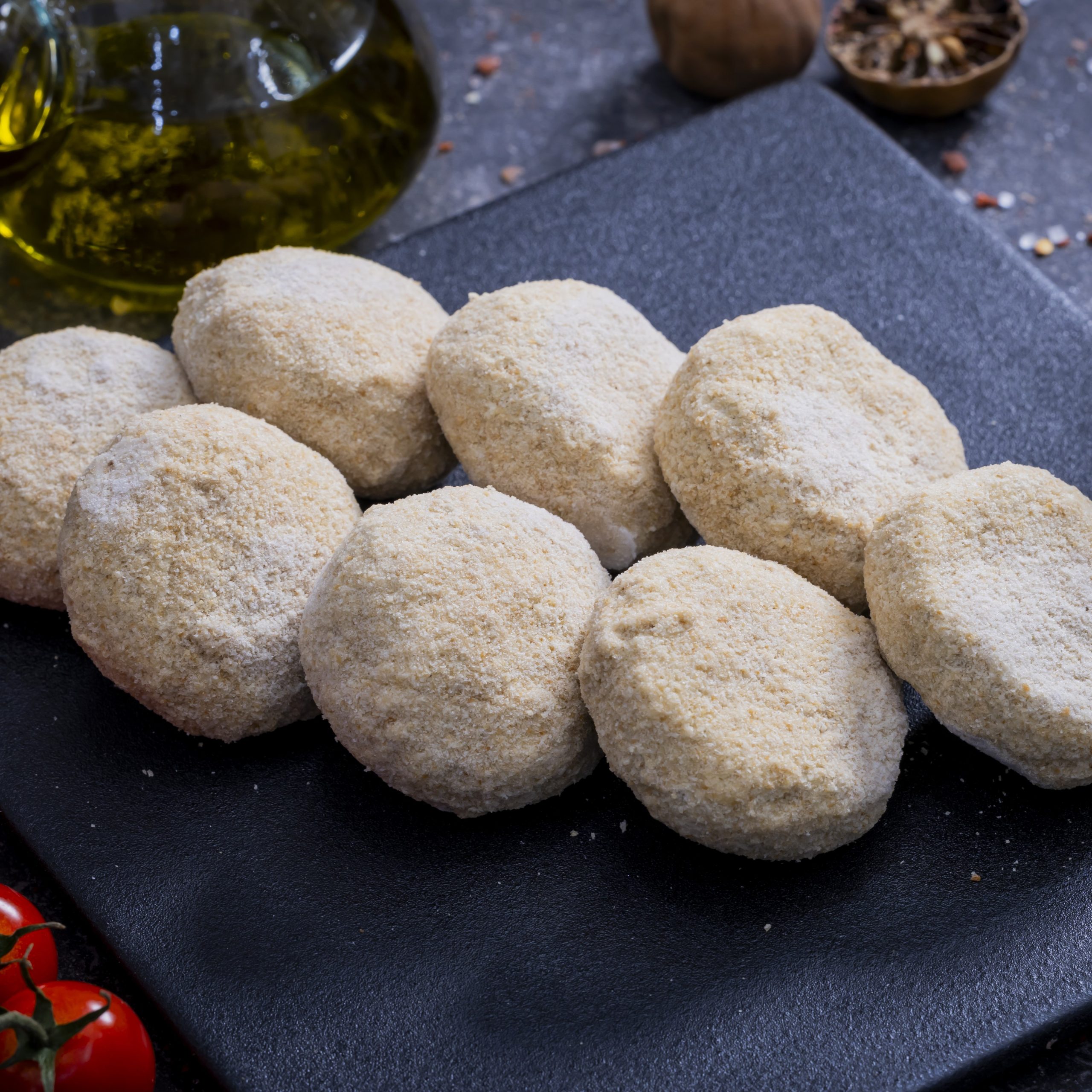 Kebbeh Sajyeh - <p>Cracked bulgur combined with minced meat, onions, spices, stuffed with a mixture of minced meat, pine nuts, and pomegranate molasses, formed into discs.</p>