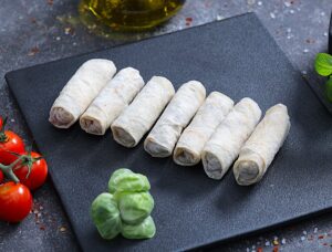 Raw meat-filled lavash rolls ready to cook on a slate board - fresh prepared meals at The Meat Master Butchery