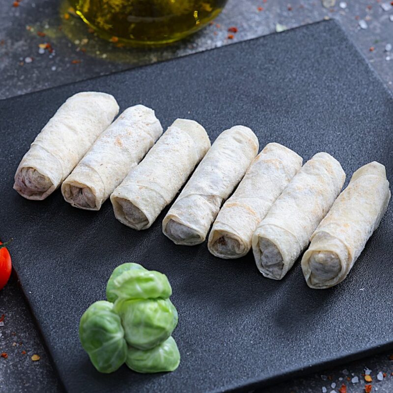 Raw meat-filled lavash rolls ready to cook on a slate board - fresh prepared meals at The Meat Master Butchery
