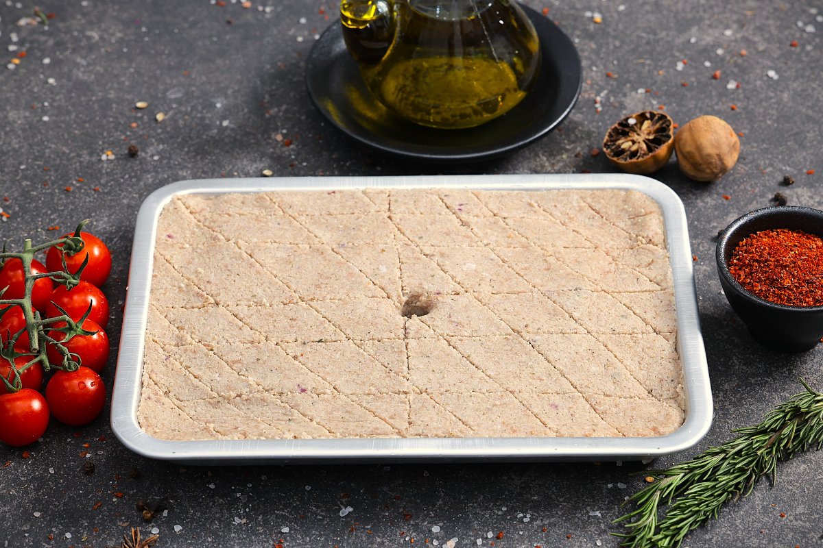 Raw kafta minced meat pressed flat in a tray with diamond scoring - fresh from The Meat Master Butchery