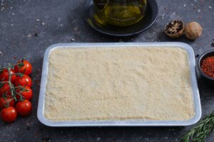 Fine semolina-coated kibbeh base pressed in a tray ready for preparation - The Meat Master Butchery