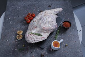 Whole raw herb-marinated chicken overhead shot on slate board - The Meat Master Butchery