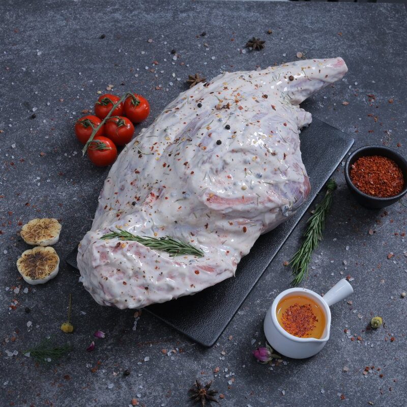 Whole raw herb-marinated chicken overhead shot on slate board - The Meat Master Butchery