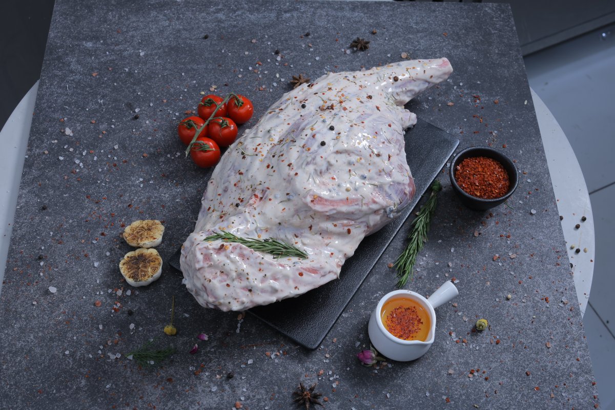 Whole raw herb-marinated chicken overhead shot on slate board - The Meat Master Butchery