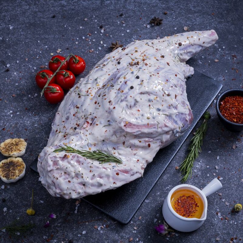 Whole raw chicken marinated in herb yogurt sauce on a slate board - The Meat Master Butchery